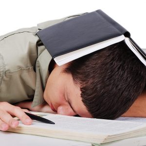 Young man fallen asleep after long reading