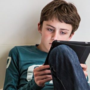 Teen boy on ereader